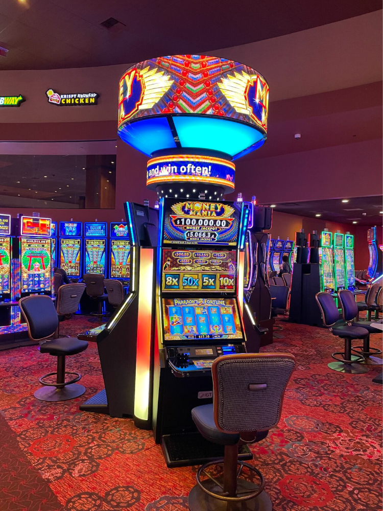 IGT's Money Mania Wide Area Progressive slot game on a casino floor. 