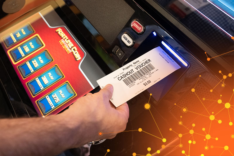 A person taking their  cashout  voucher from a gaming terminal using IGT EZ Pay