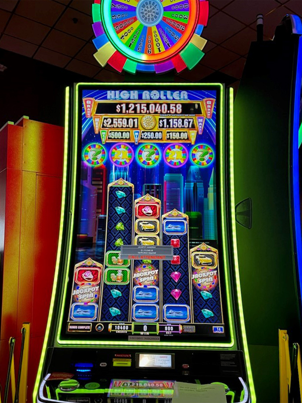 A jackpot winner notification for $1,215,040 on IGT's Wheel of Fortune High Roller wide area progressive video slot game.