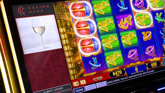 A slot game with the IGT service window for players to order beverages to their seat. 